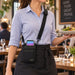 Restaurant server wearing a black Agoz crossbody holster with Stripe Reader S700/S710 during front-of-house service