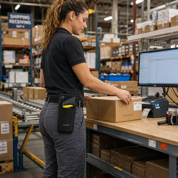Warehouse worker using a packing station with a Cognex device secured in a black Agoz waist belt case.