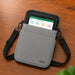 Gray AgozTech tablet carrying case with adjustable shoulder sling shown on a wood tabletop with a JLT tablet inserted.