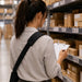 Warehouse worker wearing the padded crossbody shoulder strap while completing an inventory check