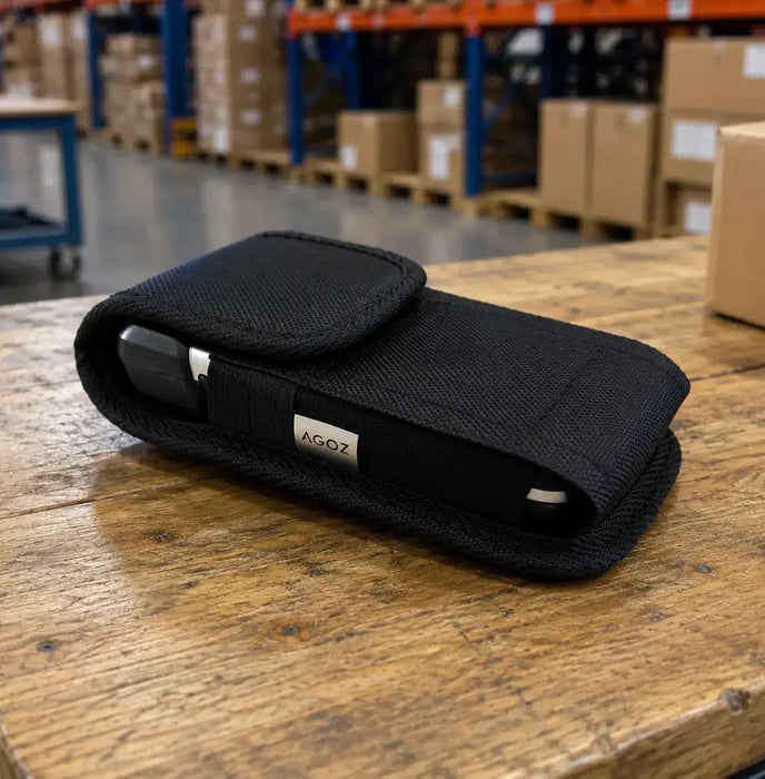 Janam mobile computer in a belt clip case on a shipping table