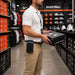  A man with Elo scanner holster carrying a shoe box in a sports equipment store