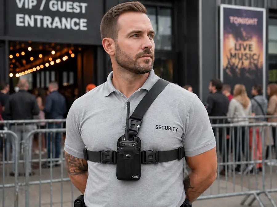 Security worker wearing chest harness pouch for L3Harris two-way radio outside a concert venue