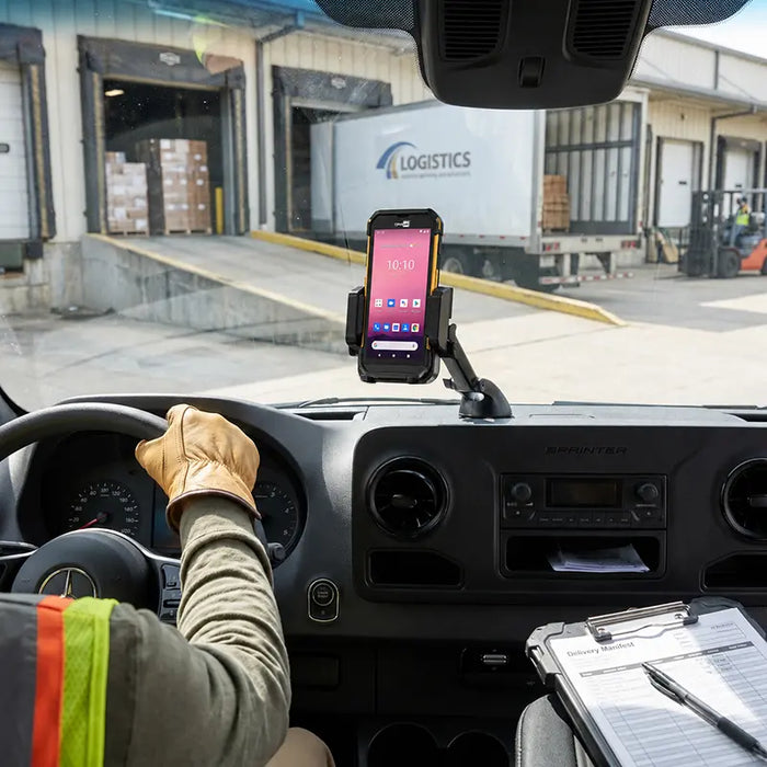 Cipherlab mobile scanner mounted on a delivery vehicle dashboard using an AgozTech cradle holder at a warehouse loading dock.