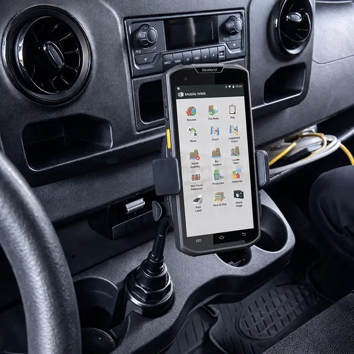 Newland mobile computer secured in a cup holder vehicle cradle mount inside a commercial vehicle console.
